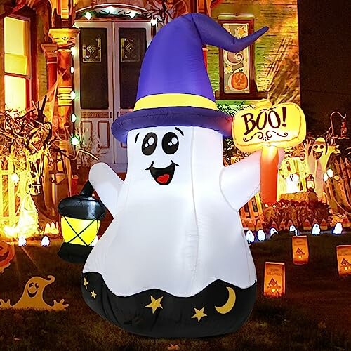 Inflatable ghost in wizard hat holding a lantern in front of a decorated house.