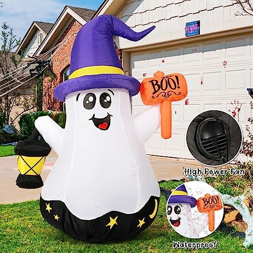 Inflatable Halloween ghost with purple hat and lantern.