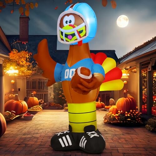 Inflatable turkey wearing a football helmet and jersey in a festive autumn setting.
