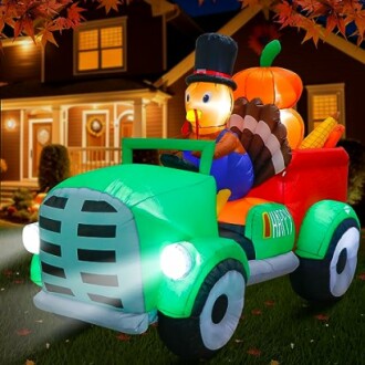Inflatable turkey and pumpkins in a truck decoration in front of a house